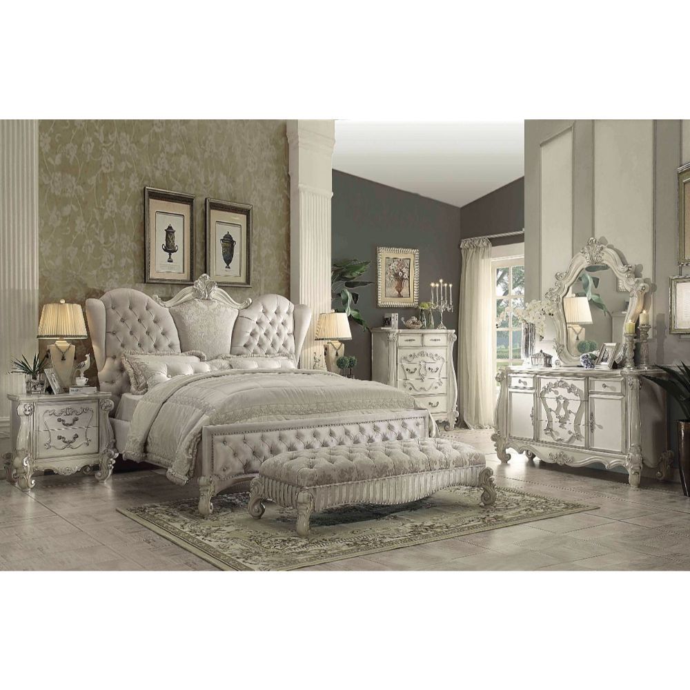 The Versailles Collection harmonizes traditional details with functional design to accommodate today-'s styles. This bedroom collection features bone white veneers, nailhead trim accents, button tufted headboard/ footboard, padded side rails, and hand-car