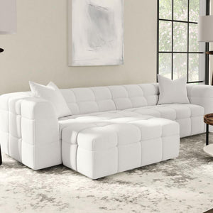  this ottoman can be used as extra seating or a convenient footrest. Wrapped in soft textured boucle upholstery