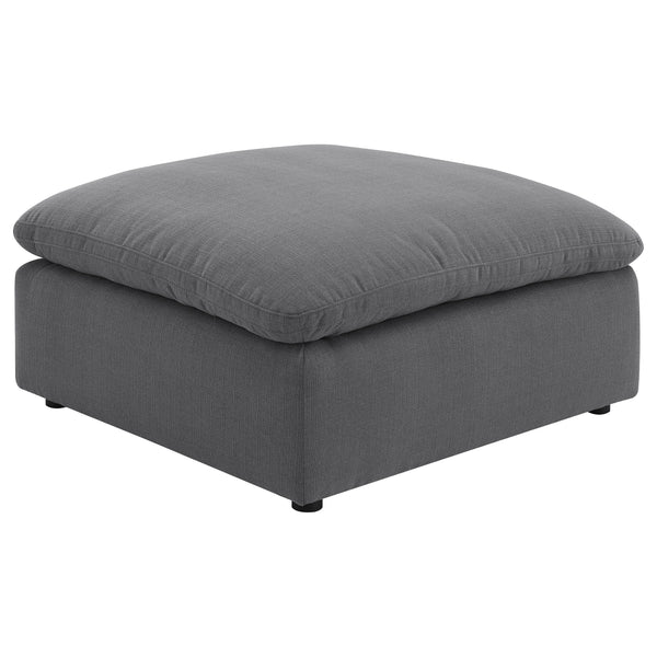 Elevate your living space with this versatile and stylish ottoman, perfect for adding both comfort and functionality to your home. Upholstered in a chic charcoal grey performance fabric, this ottoman offers a modern touch that complements a wide range of 