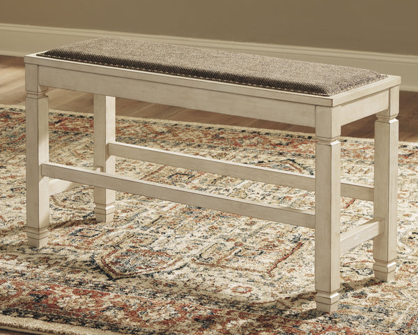  this generously scaled counter-height bench entices with a cushioned seat covered in a heavy woven fabric that complements the antiqued white finish.<br><br><