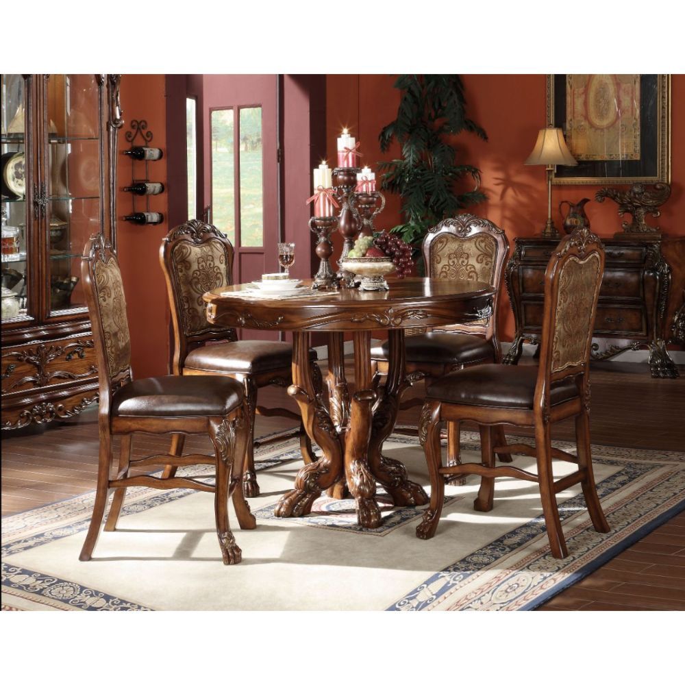 The Dresden traditional collection reflects highly decorative details, pedestal table, oversized claw feet and decorative carving inlay veneers on apron. The dining chairs reflect carefully selected wood carving and upholstery in a symphony of material. M
