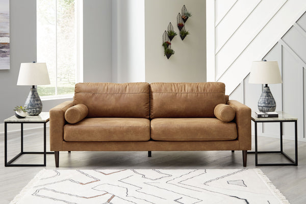  tailored to perfection. This sofa echoes retro aesthetics with warm caramel faux leather
