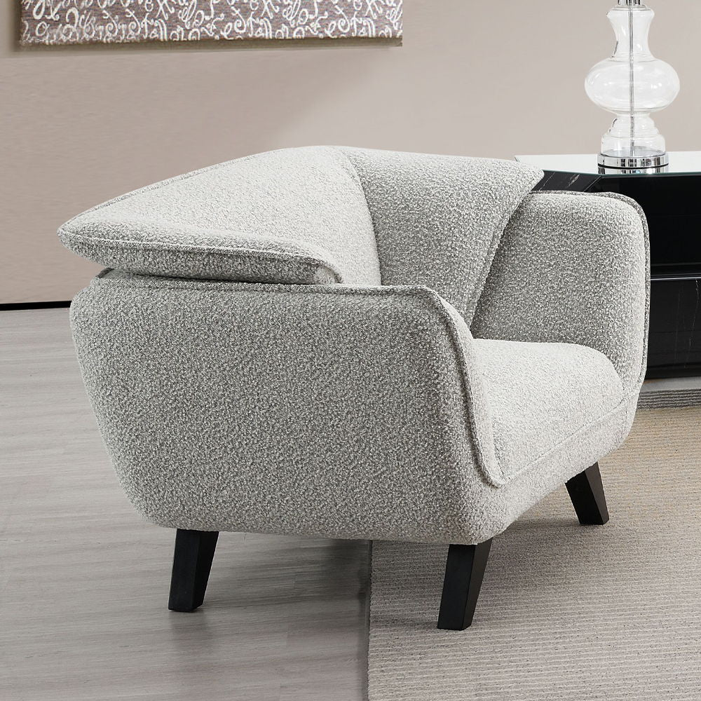 Unwind in the sophisticated charm of the Manon sofa, draped in light gray fabric. Accompanied by plush pillows, it offers a perfect blend of comfort and style. This sofa invites cozy conversations and serene relaxation, making it an ideal addition to any 