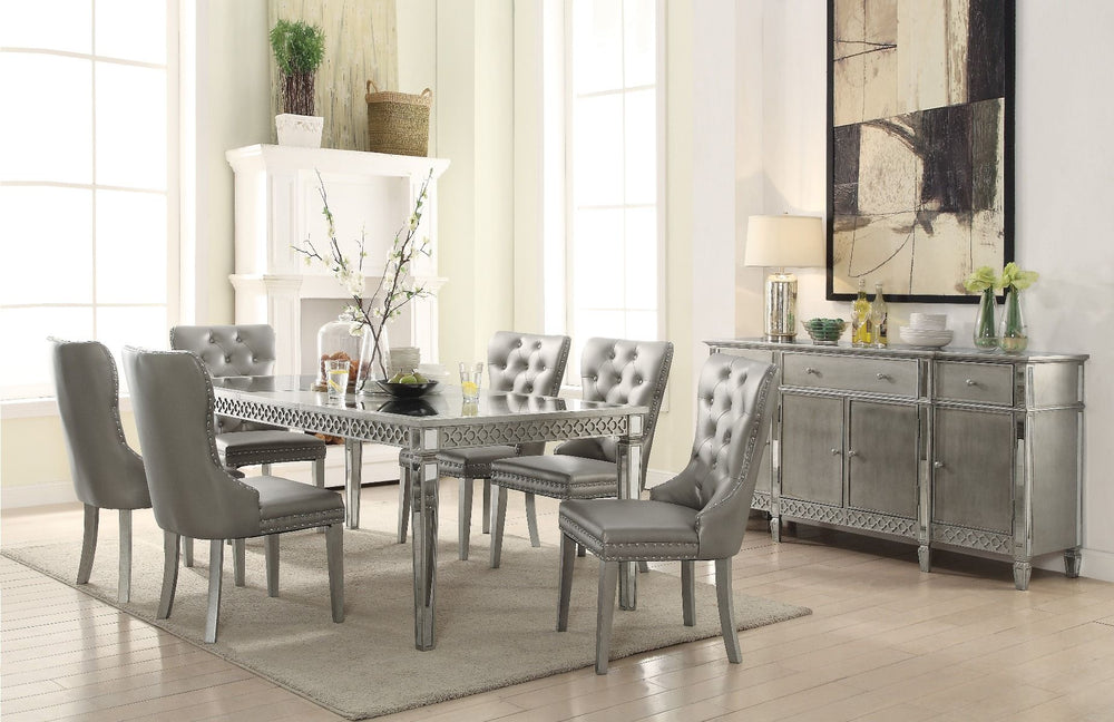 Crafted with past and present in mind, our Kacela dining collection revitalizes and transforms traditional designing ideas. A grand centerpiece, the rectangular table is handsomely finished and enriched by tapered legs and mirror insert top and edges. Pai