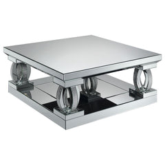 This 40-inch square coffee table brings bold, contemporary style to your living space. With its mirrored surfaces and sturdy construction, it features a large, symmetrical top and matching base for visual balance. Sculptural, oval-shaped supports adorned 