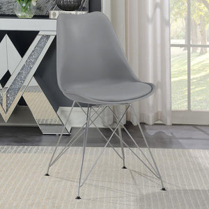  this grey dining chair beautifully updates a contemporary home with its stylish silhouette and sleek materials. The seat and back are covered in smooth leatherette upholstery