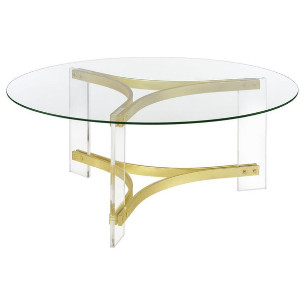 This round coffee table features a clear tempered glass top, offering an elegant surface for any living room. The sleek, clear acrylic legs enhance the modern design, while the matte brass electroplated frame provides a luxurious touch. Its minimalist con