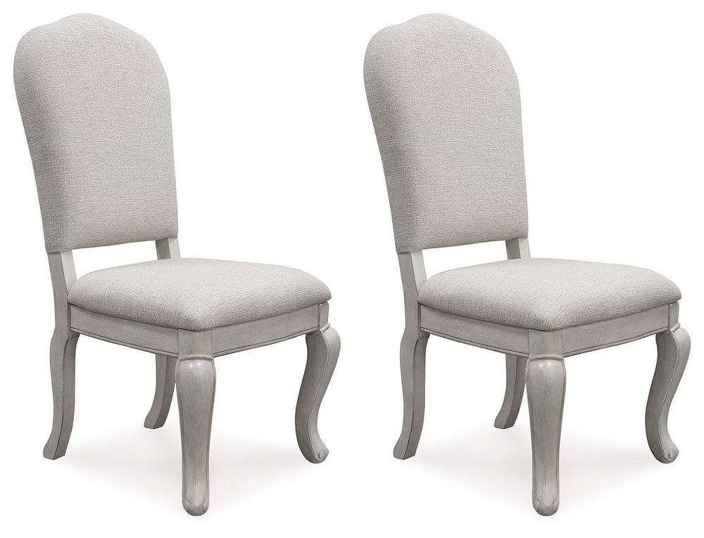 Add a touch of romance to your home with this dining chair. Its antiqued white painted finish and shapely silhouette are all about easy elegance. The graceful chair, with a cushioned back and seat and cabriole-shaped front legs, adds a dash of sophisticat