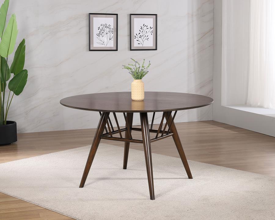 A charming basket detail adds to the mid-century charm of a round dining table. The wood table features a sap walnut veneer tabletop with a deep, rich walnut wood finish, creating a refined touch in your kitchen or dining room. Underneath, flared legs fea