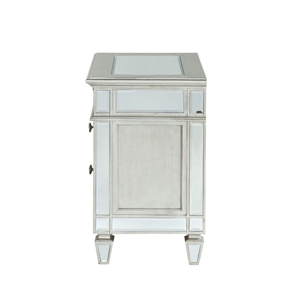 The Varian nightstand provides a commanding presence in any room. Add a dash of glam to your bedroom with this Varian nightstand, it features four tapered legs and 2 storage drawers with crystal-like knobs. This gorgeous nightstand is accented with raised