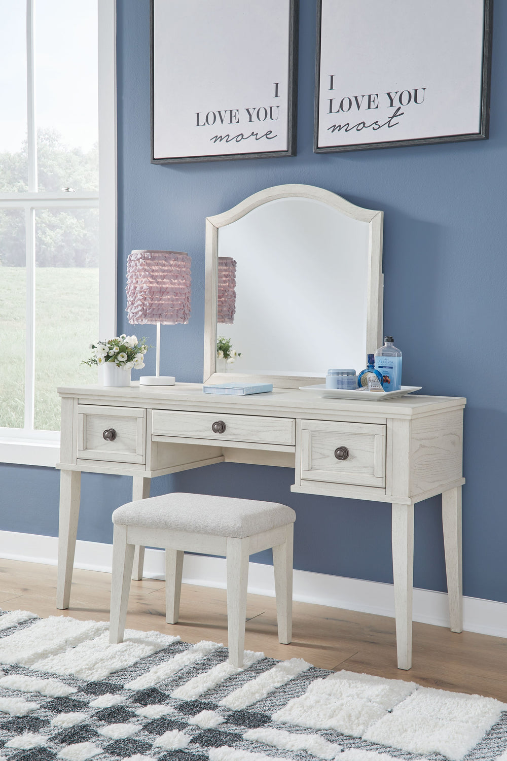Elegant, timeless furnishings take your bedroom to the next level. Nothing does that better than this mirrored vanity with bench. The antiqued white finish with a wonderful grain texture radiates sophistication, while dark bronze-tone knobs add an ornate 
