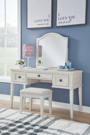 Elegant, timeless furnishings take your bedroom to the next level. Nothing does that better than this mirrored vanity with bench. The antiqued white finish with a wonderful grain texture radiates sophistication, while dark bronze-tone knobs add an ornate 