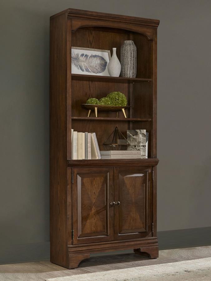 This traditional style bookcase is enhanced with beautiful molded detailing. Two bottom cabinet drawers offer concealed storage for small items. Three open shelves allow you to neatly organize your items. Molded accents on the frame and a curve at the top