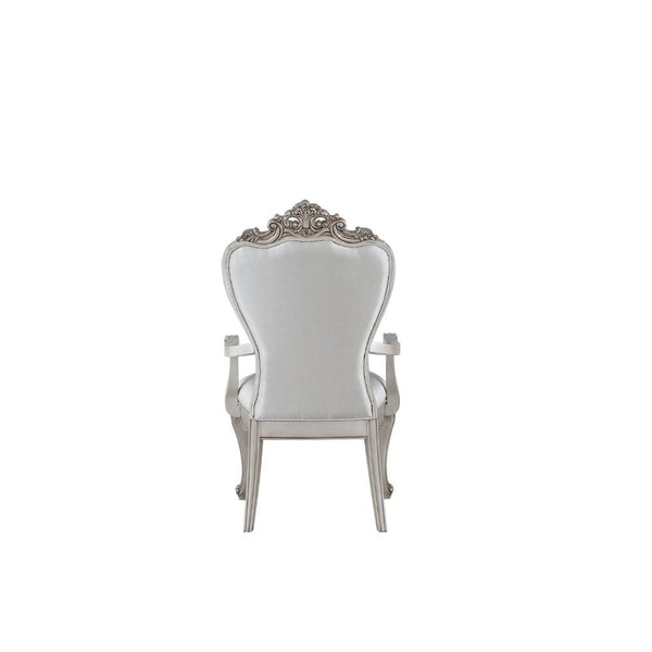  decorated with raised and scrolled floral motifs in an antique champagne finish. This unique chair is upholstered in a cream fab