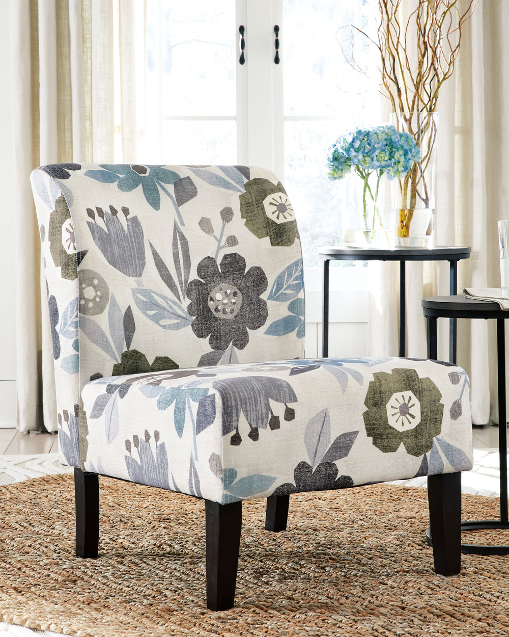 This fashion-forward accent chair adds a cool vibe to your home. Armless design is perfect for small spaces that need a spark of color. The ivory, blue, charcoal and brown floral-patterned upholstery will brighten your space and bring in an element of com