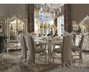 Irresistibly inviting, the Versailles collection displays the unrivaled beauty of the traditional dining. The dining table reflects highly decorative base with oversized scrolled feet, and the upholstered and tapestried chairs with the deep button tufted 