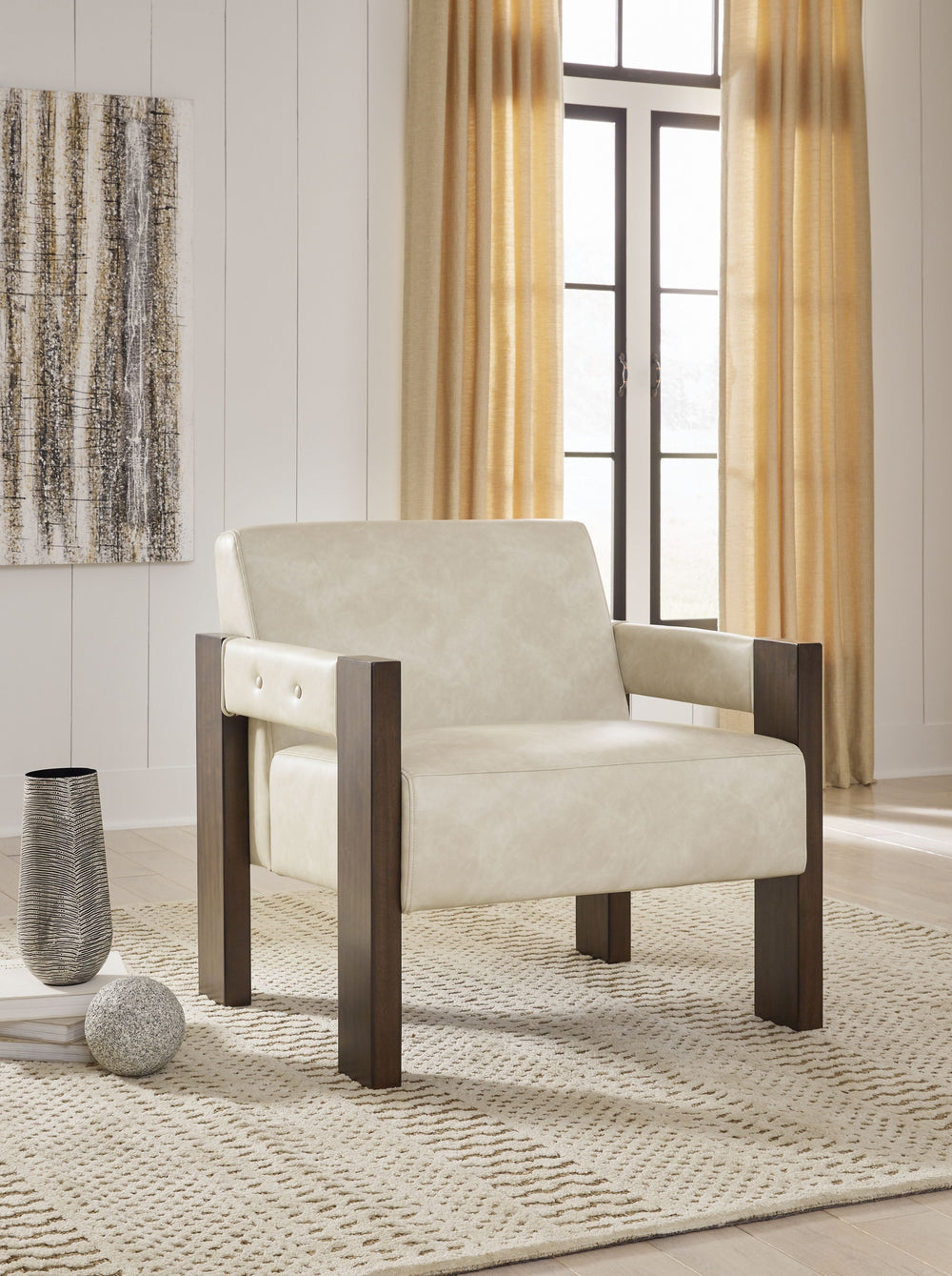 This accent chair is an ultra-contemporary addition to your seating area. Warm espresso-hued wood and neutral faux leather harmonize beautifully for a luxuriously welcoming vibe. Whether you-'re cozying up with coffee or settling in to stream your favorit