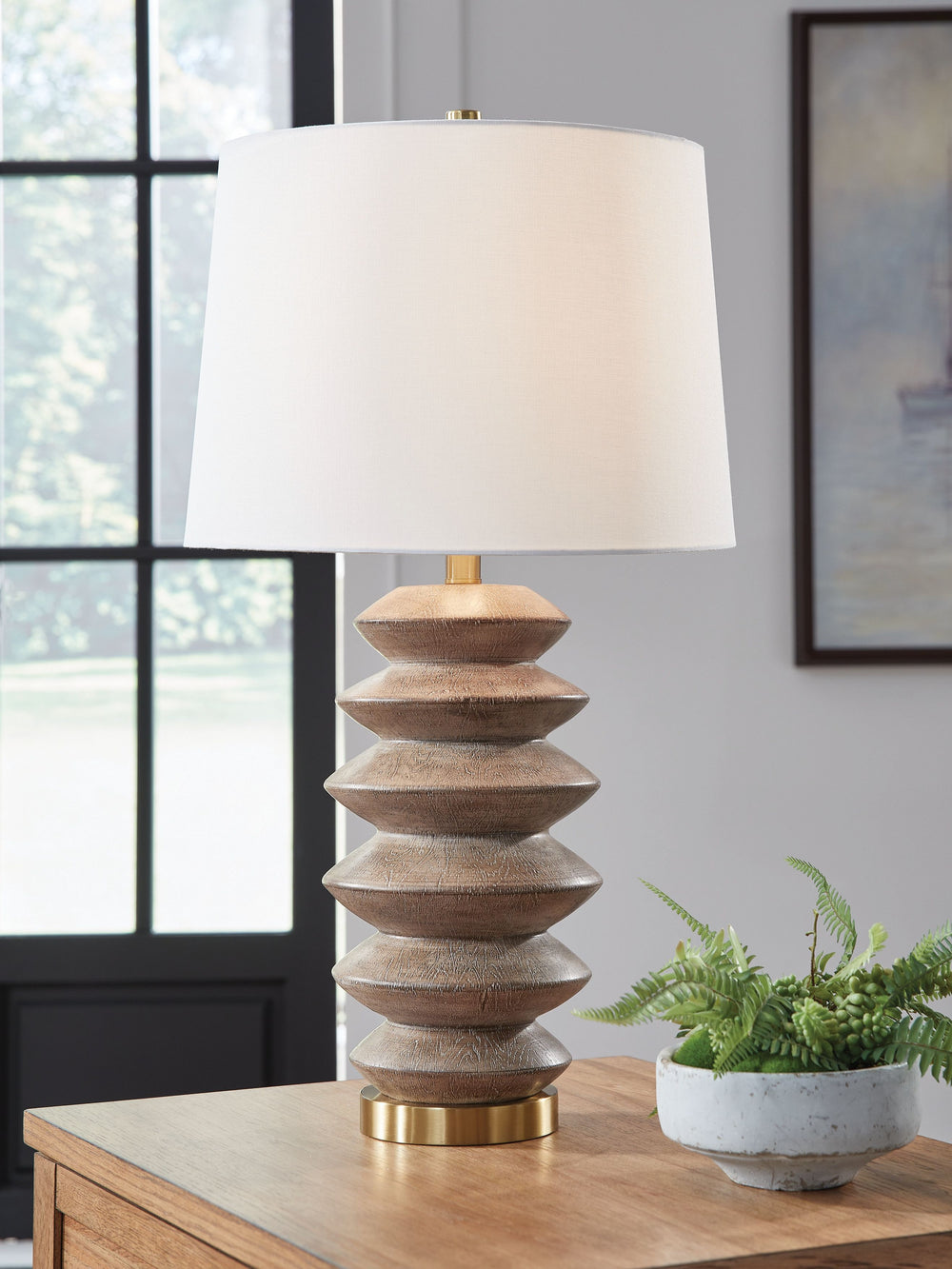 Express your taste for cool construction and inviting vibes. In a light brown faux wood pattern, this table lamp brings a fresh feel to an end table or nightstand. A goldtone metal accent gives it a mixed-media feel for added refinement.<br><br><b>Additio