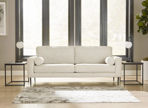  the slim-profiled piece welcomes you with its cozy character. A subtle chevron pattern on the cushions refresh the classic neutral hue