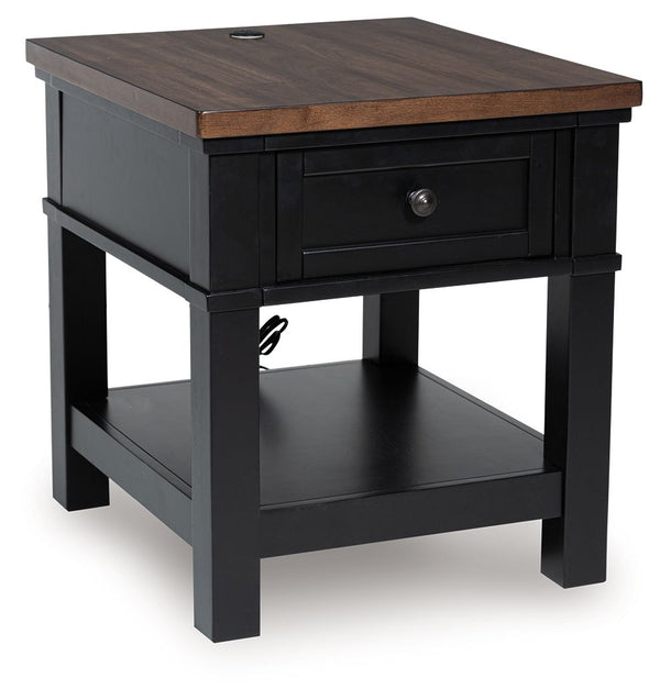 Raise the bar on modern farmhouse style with this end table. Its sturdy silhouette and casual good looks are accentuated with a two-tone finish, which pairs a warm satin black base with a contrasting butcher block veneer top. A spacious storage drawer and