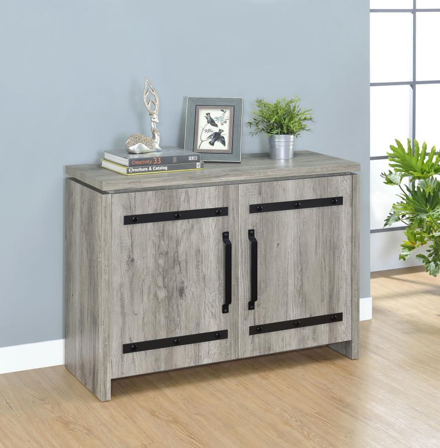 This storage cabinet features a clean-lined silhouette with industrial-inspired hardware for a functional, modern-rustic look. Crafted from engineered wood with a scratch-resistant and eco-friendly laminate veneer, it showcases a grey driftwood finish tha