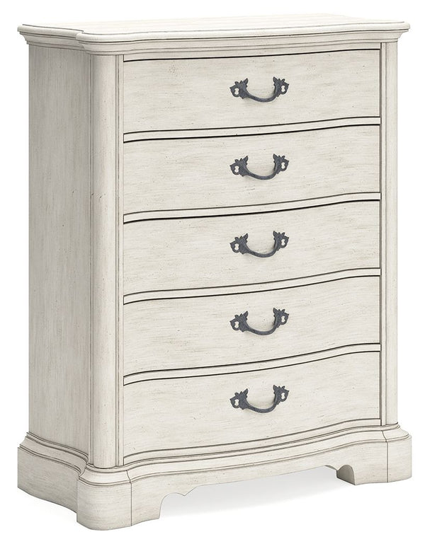 Add a touch of romance to your bedroom with this chest of drawers. Its antiqued white painted finish and serpentine-shaped silhouette details are the picture of easy elegance. Five spacious drawers offer ample storage space, while custom-designed bar pull