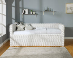 This contemporary daybed offers a luxurious and tactile experience, perfect for modern living spaces. The unique textured upholstery in a soft white dove hue makes it an eye-catching piece that doesn-'t compromise on comfort. Designed with a generous seat