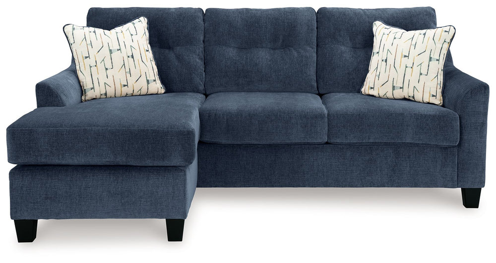 Urban contemporary meets mid century (with a pop of trend-right color) in this sofa chaise. Supremely soft upholstery, teeming with luster and movement, finesses the piece with just the right touch. Gently flared arms and tufted back cushions let you bask