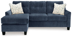 Urban contemporary meets mid century (with a pop of trend-right color) in this sofa chaise. Supremely soft upholstery, teeming with luster and movement, finesses the piece with just the right touch. Gently flared arms and tufted back cushions let you bask