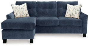 Urban contemporary meets mid century (with a pop of trend-right color) in this sofa chaise. Supremely soft upholstery, teeming with luster and movement, finesses the piece with just the right touch. Gently flared arms and tufted back cushions let you bask