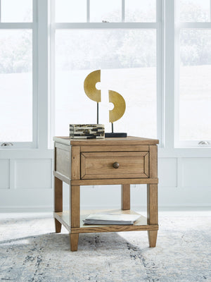  this end table brings easygoing elegance to the everyday. The light brown wood-tone finish seamlessly slips into your roomâ€™s aesthetic. A dark bronze-tone pull accents the drawer
