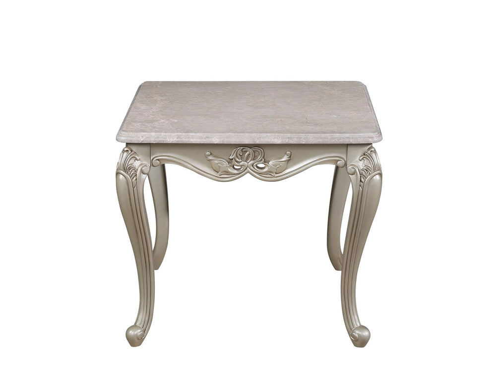 The Monique Royal Classic End Table in champagne showcases heirloom-quality craftsmanship and timeless elegance. Expertly constructed from premium pine solids and adorned with durable polyurethane carvings, this side table is lightweight, moisture-resista