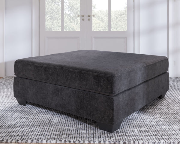 the firmly cushioned square ottoman is covered in a decadently soft