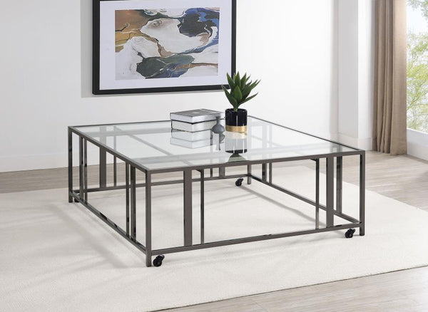  featuring a tempered glass top and a sturdy geometric base made from heavy-gauge metal. The open-frame design creates a sleek