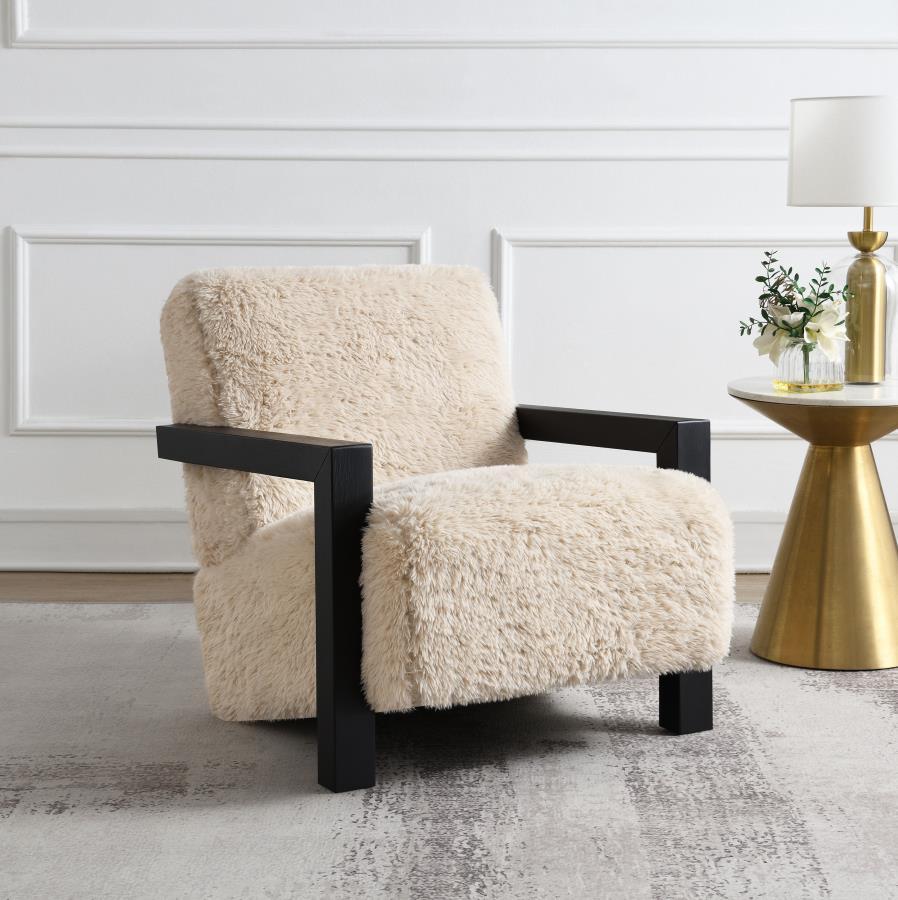 This accent chair envelops you in plush comfort, thanks to foam-padded back and seat cushions upholstered in latte faux fur. A solid hardwood frame ensures reliable support, while the luxurious texture enhances any living area or reading nook. As a statem