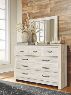 Your bedroom isnâ€™t just a room. Itâ€™s a canvas. Express your farmhouse style with this dresser and mirror set. Wispy white finish over replicated oak wood grain brightens up the space with charm. Brushed nickel-tone handles with black edging finesse th