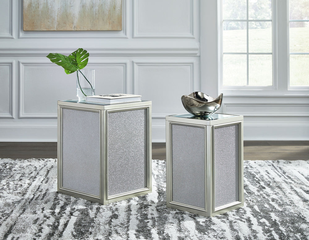 Reminiscent of Hollywood glamour of yesteryear, this set of nesting end tables interprets luxury in a decidedly modern way. A dazzling metallic silvertone finish and textured laminate panels for added luster enhance the star power, while the beveled inset