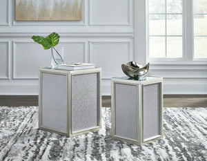  this set of nesting end tables interprets luxury in a decidedly modern way. A dazzling metallic silvertone finish and textured laminate panels for added luster enhance the star power