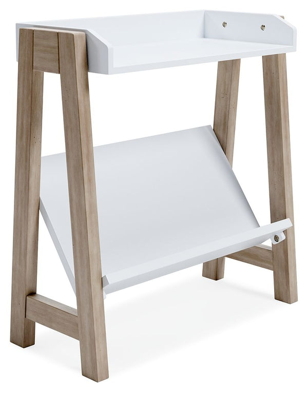Whether for storage or display, this stylish small bookcase provides the perfect place to prop their ever-expanding book collection. The unique angled lower shelf and gallery rail top in white charmingly contrast with the light tan frame, creating a versa