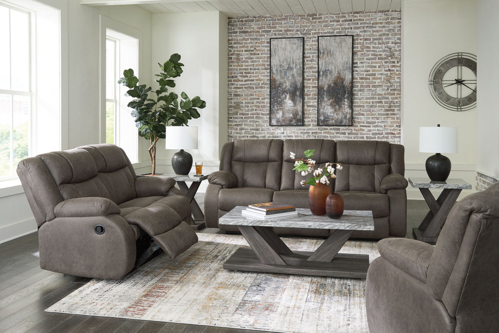 This living room set tees you up to catch up on streaming or enjoy the latest game without breaking the bank. Its easy reclining motion and inviting stitched details craft a stylish seat that keeps you utterly at ease. <h4><b>First Base - Gunmetal - Recli