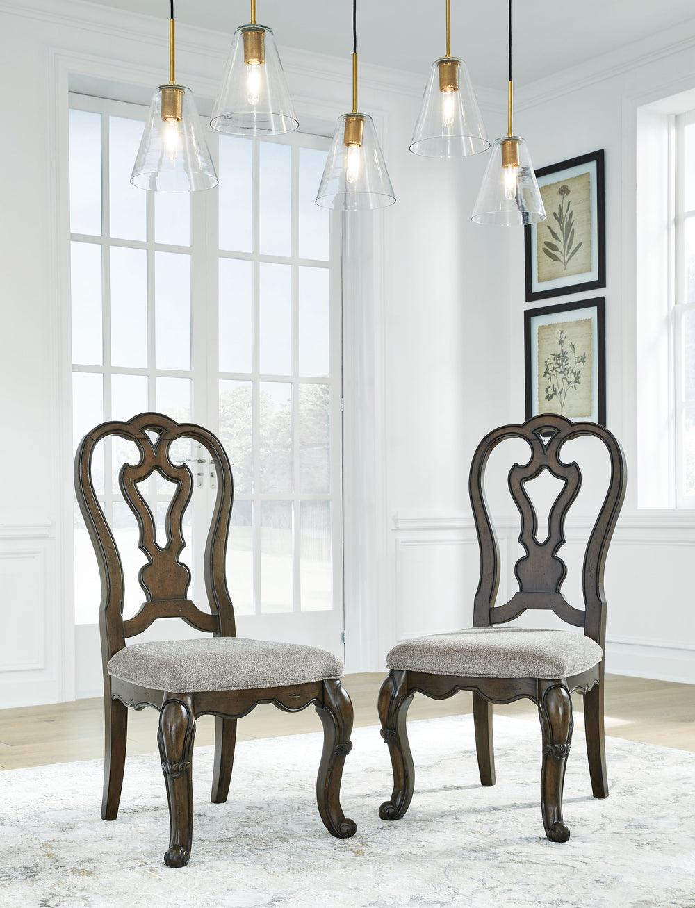 From its ornamental appliques to its large scale, this dining chair makes a bold statement. With shapely legs and a plush cushioned seat, the opulent piece wows with stunning style. The look is timeless. The feel? Right at home.<br><br><b>Additional Dimen