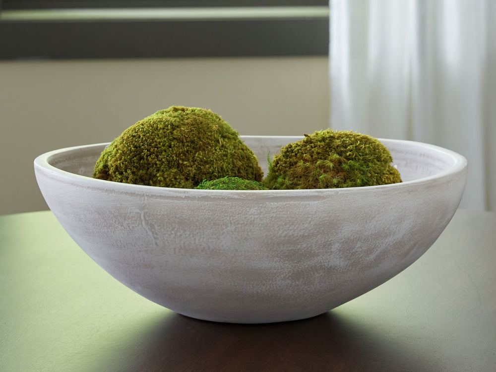 Celebrate the artisanal character of ceramics with this bowl. Its distressed white finish has a time-worn, weathered appeal, offering the look of the past with a modern feel. The bowl-'s neutral tone makes it a go-to for all seasons, allowing you to stage