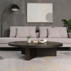 The Guido coffee table with its oak finish, exudes a blend of contemporary elegance and robust functionality. Featuring a fixed wooden table top and a round, oversized design, it is perfect for modern living spaces. The table-'s substantial presence and s