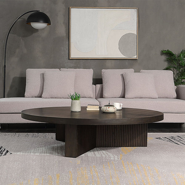 The Guido coffee table with its oak finish, exudes a blend of contemporary elegance and robust functionality. Featuring a fixed wooden table top and a round, oversized design, it is perfect for modern living spaces. The table-'s substantial presence and s