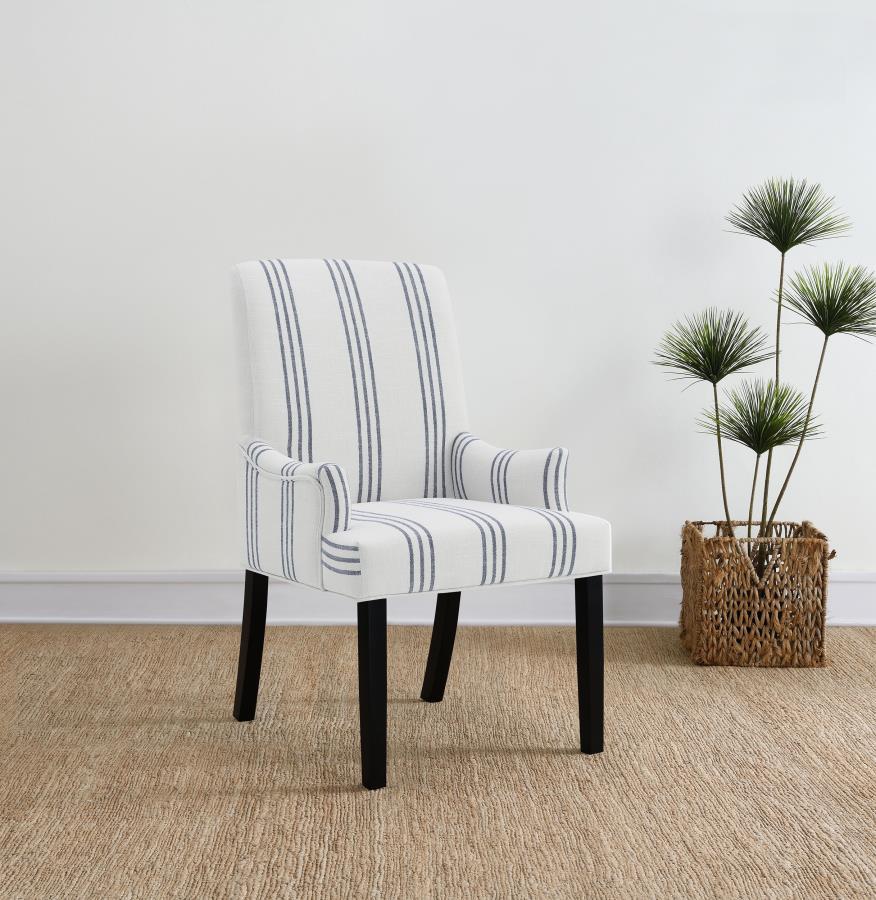 This armchair adds a refined yet relaxed charm to your dining space, blending comfort with casual elegance. Upholstered in linen-like beige fabric with blue stripes, it offers a timeless aesthetic. The padded seat, backrest, and gracefully curved arms ens