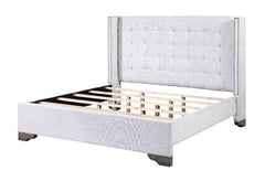 The Artesia bedroom collection provides a commanding presence in any room. This contemporary fully padded bed in tan fabric associates with button-tufted headboard with nail-head trim. Attention to details the matching case pieces are featured with raised