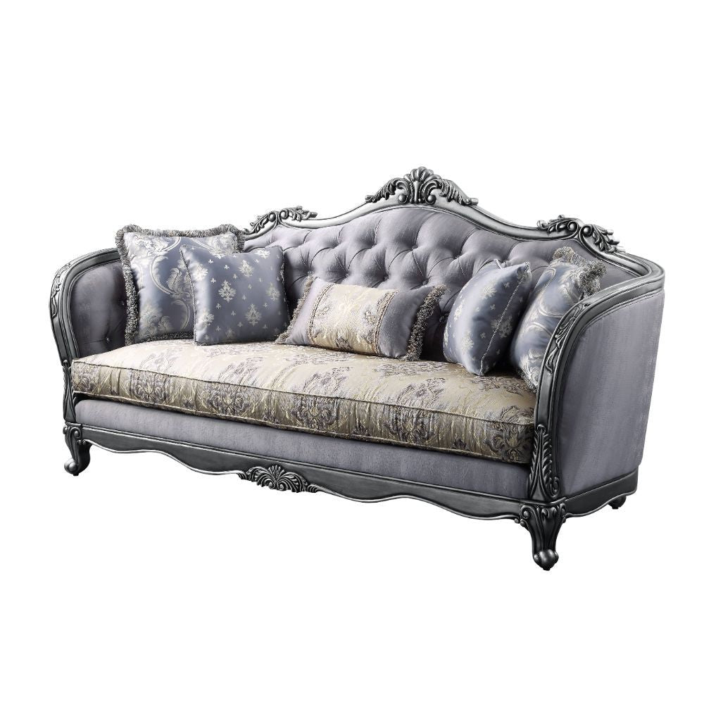 The Ariadne sofa collection is fit for royalty! The platinum finish of the wooden frame complements the lustrous upholstery over button-tufted seatback and inner armrests. Carved flourishes crown the arched seatbacks and extend down the molding around the