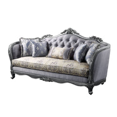 The Ariadne sofa collection is fit for royalty! The platinum finish of the wooden frame complements the lustrous upholstery over button-tufted seatback and inner armrests. Carved flourishes crown the arched seatbacks and extend down the molding around the