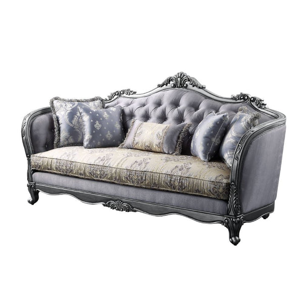 The Ariadne sofa collection is fit for royalty! The platinum finish of the wooden frame complements the lustrous upholstery over button-tufted seatback and inner armrests. Carved flourishes crown the arched seatbacks and extend down the molding around the