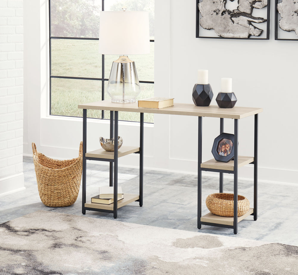 Contemporary meets casual for the ultimate office space. This desk aims to please with its durable MEGA-TUFFÂ® melamine top and metal base in a powder coated finish. The top features a replicated exotic wood grain in a light tan finish, while the double-s